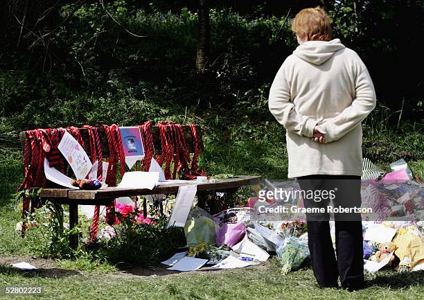 Flowers and notes are left in Prospect Park at the site of the murder of Mary-Ann Leneghan, on May 12, 2005 in Reading, England. Police are still...