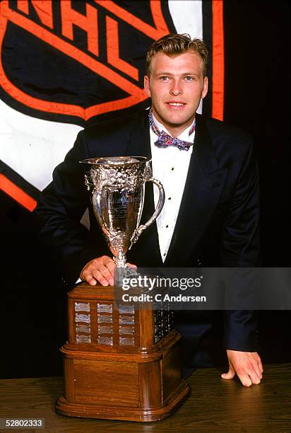 Canadian hockey player Martin Brodeur of the New Jersey Devils, dressed in a tuxedo and colorful bow tie, poses with the Calder Memorial Trophy,...