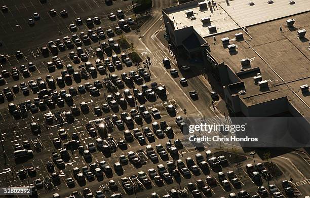 Cars lie in the parking lot of a Wal-Mart as the sun sets May 10, 2005 in Bowling Green, Ohio. Wal-Mart, America's largest retailer and the largest...