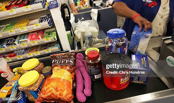 Groceries and other retail items move down the checkout counter of a Wal-Mart Supercenter May 11, 2005 in Troy, Ohio. Wal-Mart, America's largest...