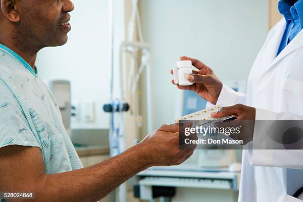 doctor handing medication to patient - patient profile stock pictures, royalty-free photos & images