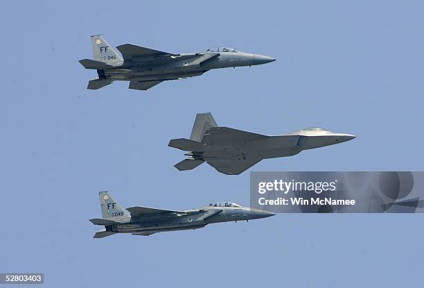 The first F/A-22 Raptor destined for the First Fighter Wing is escorted by a pair of F-15C Eagles shortly before being delivered May 12, 2005 at...