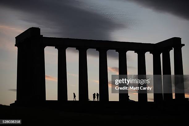 The sun sets behind the National Monument at Calton Hill on May 3, 2016 in Edinburgh, Scotland. As campaigning for the Holyrood election enters its...