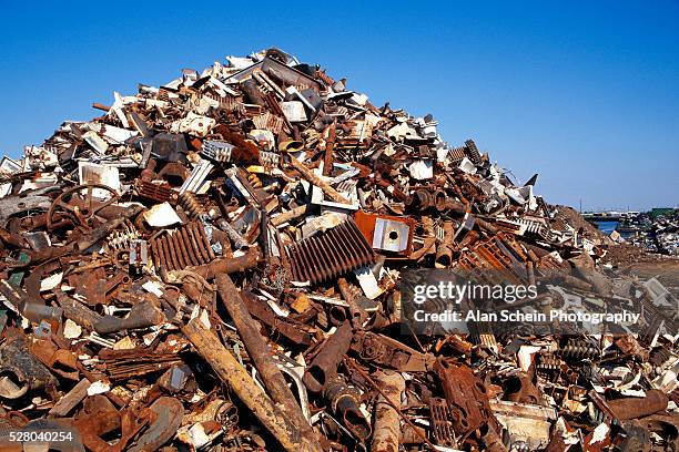 pile of scrap metal in junkyard - junkyard foto e immagini stock