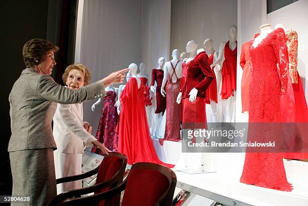 First lady Laura Bush and former first lady Nancy Reagan look at dresses after an unveiling event at the Kennedy Center May 12, 2005 in Washington,...