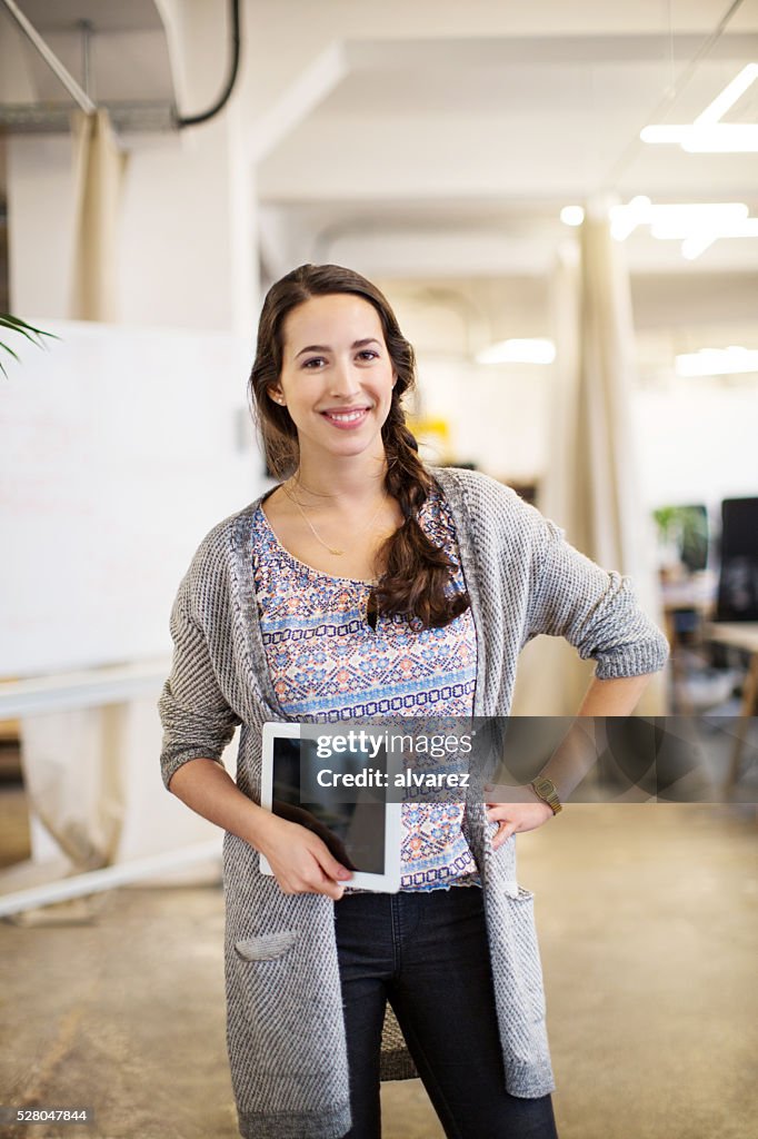 Cool businesswoman holding digital tablet