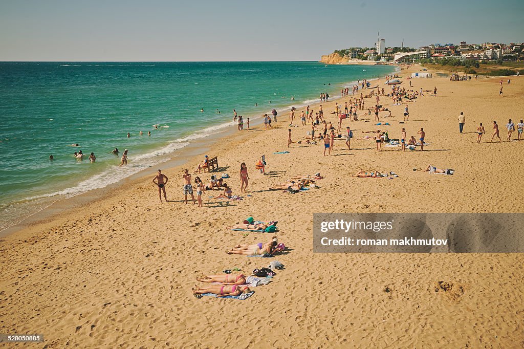 A lot of people relaxing on a beach