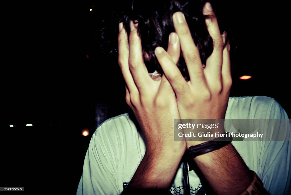 Man holding his face in his hands
