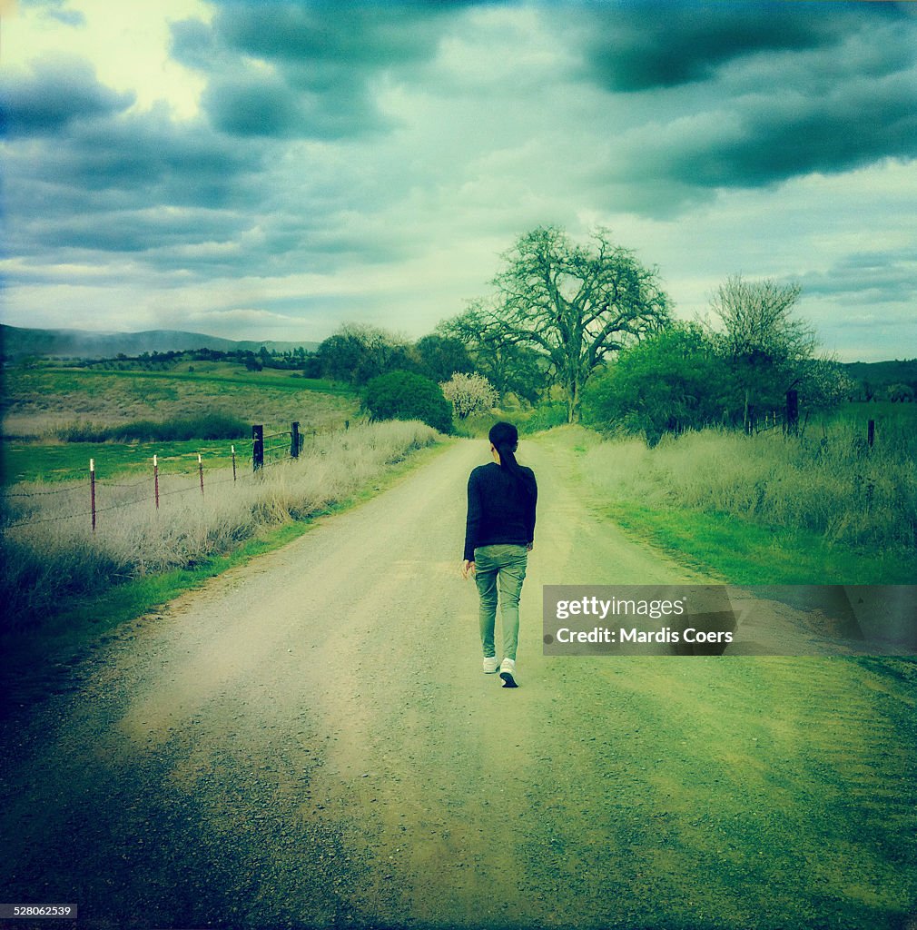 Woman walking on a country road