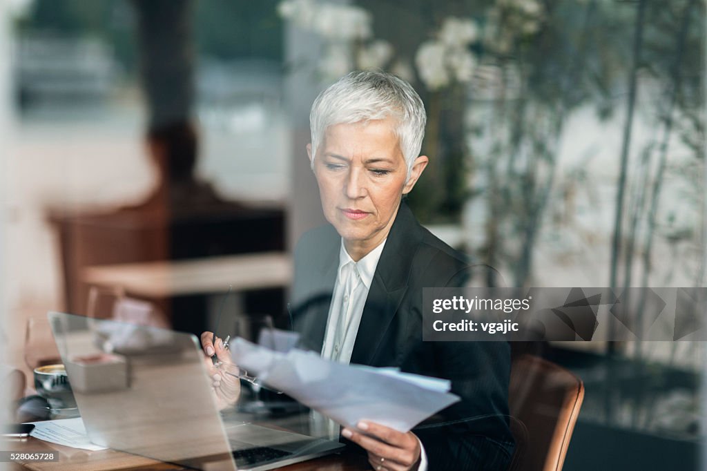 Mature businesswoman Working On Her Laptop.