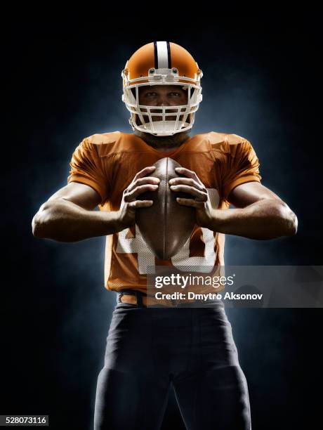 american football player - playing football stock pictures, royalty-free photos & images