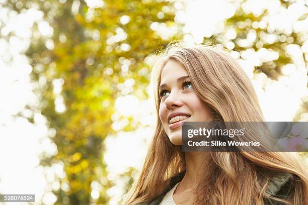 portrait of a young teenage girl with brackets - 14 year old blonde girl stock pictures, royalty-free photos & images