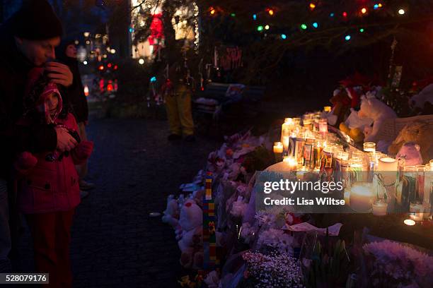 Safe in her fathers arms…Rich Demers holds his daughter Anahya from Meriden, CT. As they join other members of the public paying their respects at...