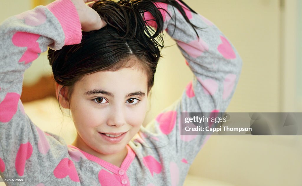 Child tying her hair up