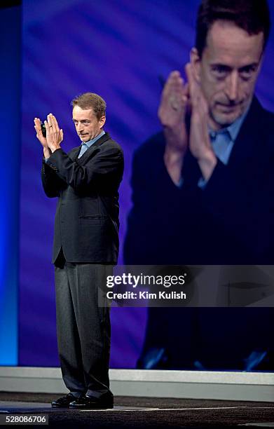 Incoming VMware CEO Pat Gelsinger claps in appreciation of outgoing CEO Paul Maritz during a VMworld keynote presentation at the Moscone Center in...