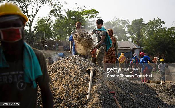 Workers produce tarmac for the road construction on April 11, 2016 in Khulna, Bangladesh.