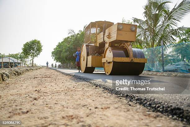 Steamroller compresses asphalt on April 11, 2016 in Khulna, Bangladesh.