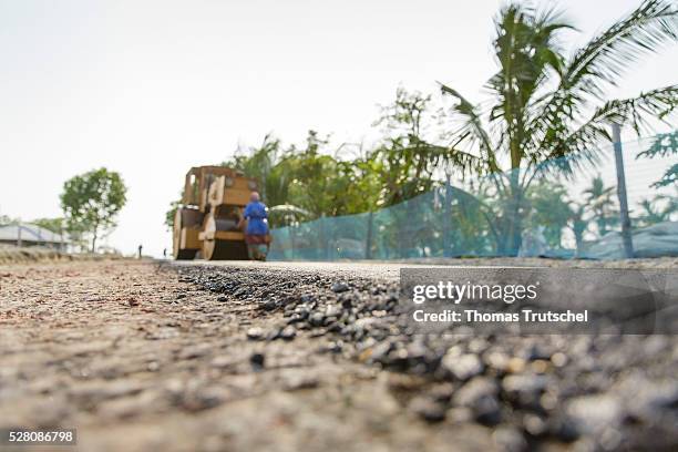 Steamroller compresses asphalt on April 11, 2016 in Khulna, Bangladesh.