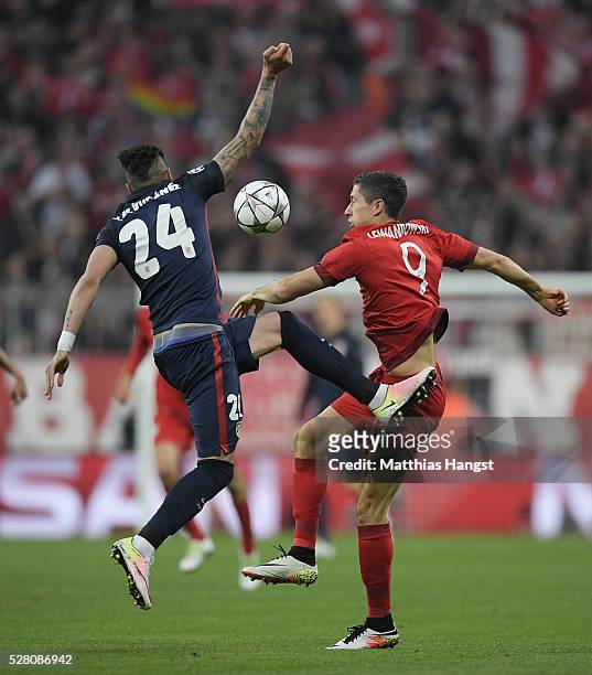 Jose Maria Gimenez of Madrid jumps for a header with Robert Lewandowski of Muenchen during the UEFA Champions League semi final second leg match...