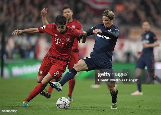 Javi Martinez of Muenchen and Fernando Torres of Madrid compete for the ball during the UEFA Champions League semi final second leg match between FC...