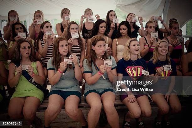 Identical twin sisters gather on stage to await judging in a look-alikes during the the 32nd annual Twins Days Festival in Twinsburg, Ohio August 4,...