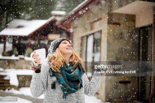 young woman enjoying the first snow - correction fluid stock pictures, royalty-free photos & images
