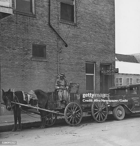 Black and white photograph of a street scene in Alexandria, Louisiana, the site of race riots during World War II which started when African-American...