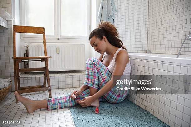 young woman doing pedicure - aqua nail polish stock pictures, royalty-free photos & images