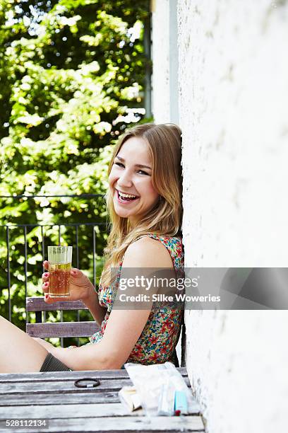 woman sitting on balcony and drinking - apple juice stock pictures, royalty-free photos & images