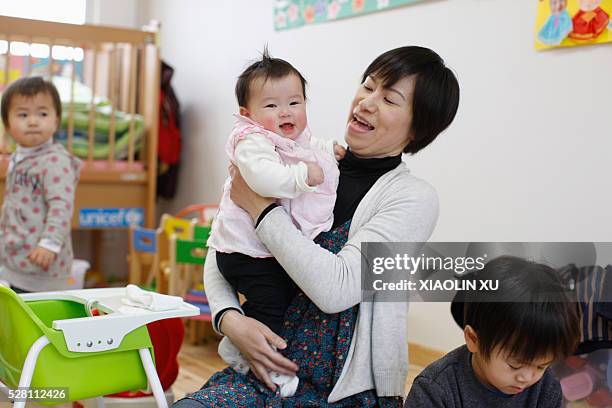 At March 10 Kirikiri, Otsuchi, Iwate, Japan. In a temporary nursery, Tanaka akie comforts her daughter of Tanaka .Tanaka aoba was born in the...