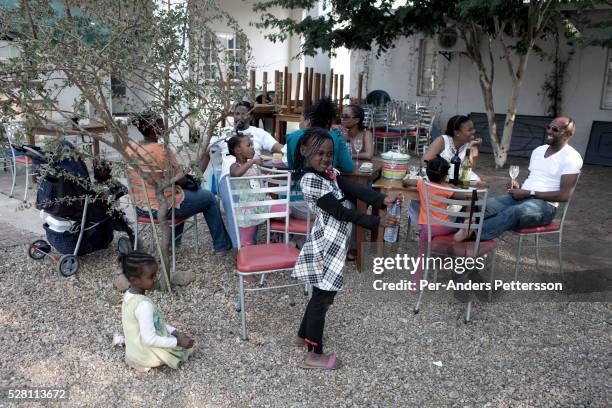 Middle class families enjoy an outdoor picnic outside Gaborone, Botswana.