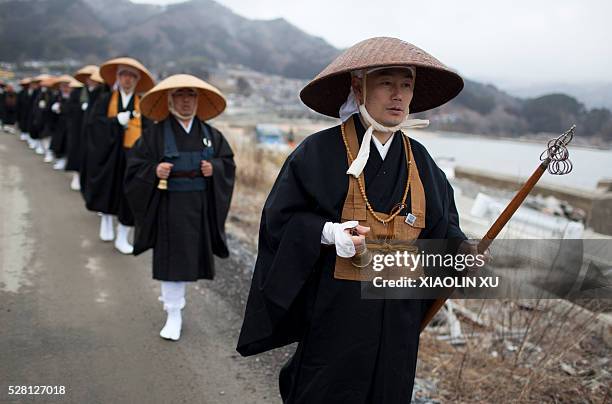 Monks chanting for victims at tsunami debrisin Kirikiri village, Otsuchi, Iwate, Japan in March 12, 2012. The tsunami deprived the lives of four...