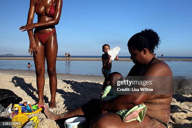 Families from the nearby favelas spending the afternoon on Sao Conrado beach, where the high tide left pools of water on July 12 ,2010. Photo by Lisa...