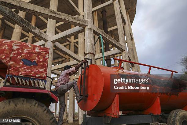 Worker fills a water tanker at the Vivekananda Chowk water tank in Latur, Maharashtra, India, on Saturday, April 16, 2016. Hundreds of millions of...