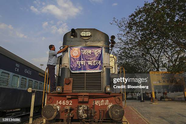 Banner is tied to the front of a train pulling water tankers at Latur railway station in Latur, Maharashtra, India, on Saturday, April 16, 2016....