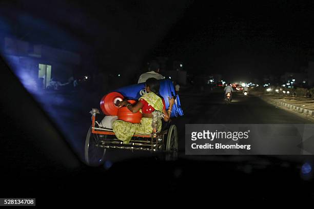 Water commuter transports empty containers on the back of a tricycle in Latur, Maharashtra, India, on Saturday, April 16, 2016. Hundreds of millions...