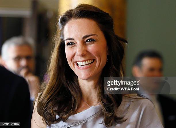 Catherine, Duchess of Cambridge laughs as she speaks with guests during a reception in support of The Anna Freud Centre on May 4, 2016 at Spencer...