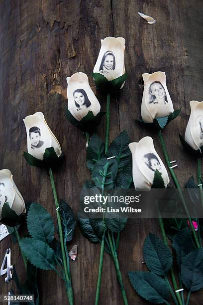 White roses with images of the victims of the tragedy in Sandy Hook on a telegraph pole in the town centre after the mass shootings at Sandy Hook...