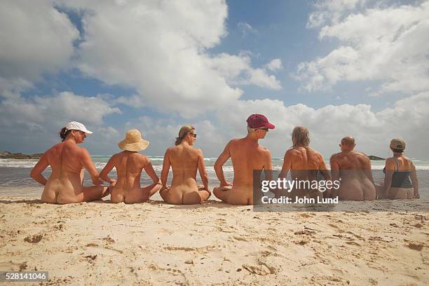 nudists on beach - bare beach stock pictures, royalty-free photos & images