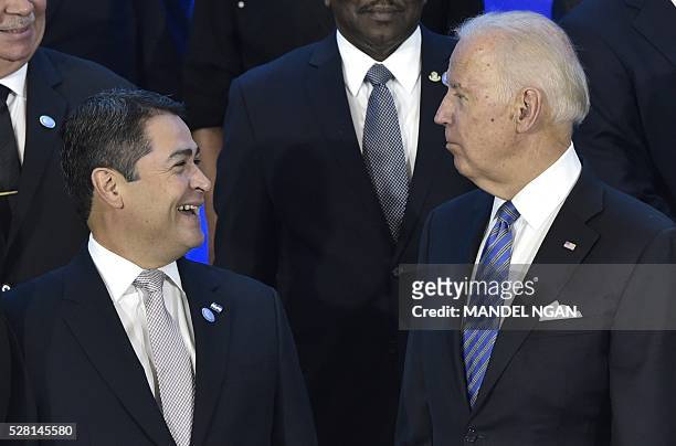 Vice President Joe Biden chats with Honduras President Juan Orlando Hern������ndez while posing for a group photo during the US, Caribbean, Central...