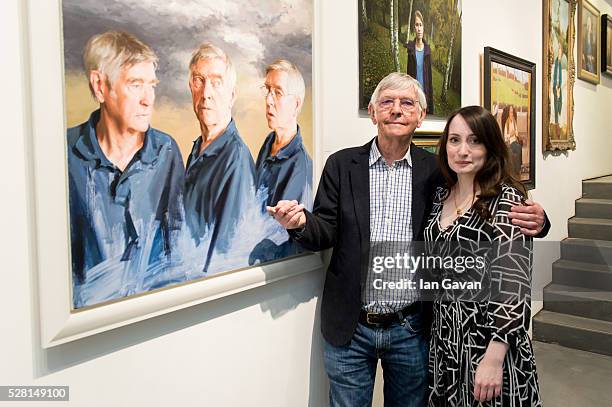 Sir Tom Courtenay and Artist Isobel Peachey pose next to his portrait at the Royal Society of Portrait Painters Photocall at the Mall Galleries on...