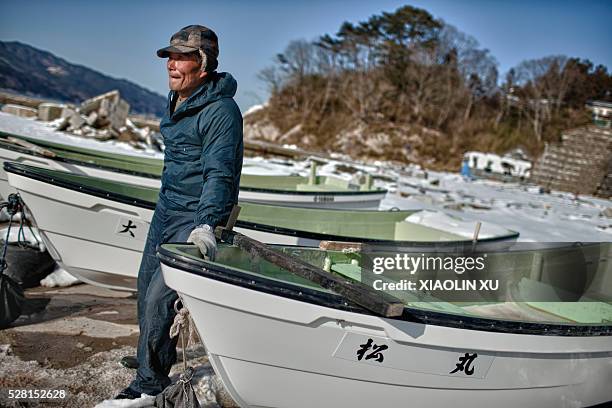 March 1 at Kirikiri, Otsuchi, Iwate, Japan. A 67-year-old fisherman Matsuo Kusara paints his new boat. This motor boat is JPY800 Matsuo spent only...