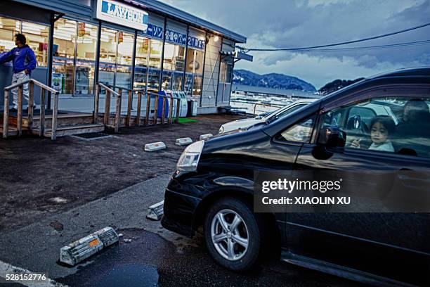 Feb 2012, at Kirikiri, Otsuchi, Iwate, Japan. Villagers drove away after shopping. This convenience store resumed two months ago, it is no longer...
