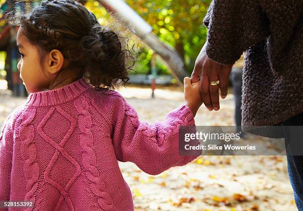 mother and daughter (2-3) in park - african american couple walking park ストックフォトと画像