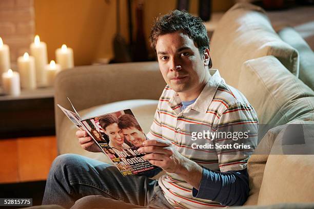 Actor Jimmy Fallon reads a copy of "US Weekly" during filming for a promo for the 2005 MTV Movie Awards at Paris Studios May 12, 2005 in Queens...