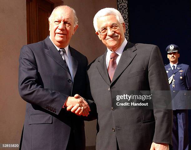 Palestianian President Mahmoud Abbas and Chilean President Ricardo Lagos shake hands outside the La Moneda government palace May 12, 2005 in...