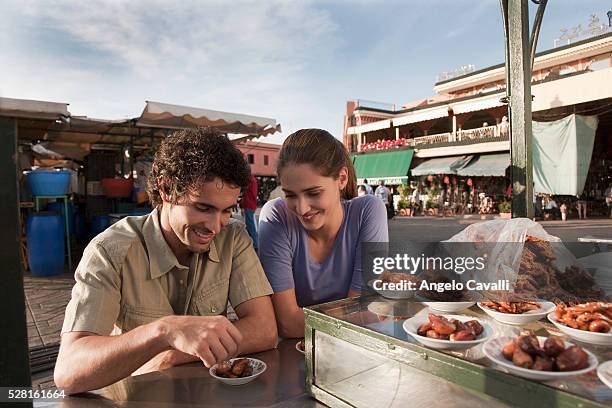 tourists eating at a food stand - marokko marrakesh stock-fotos und bilder