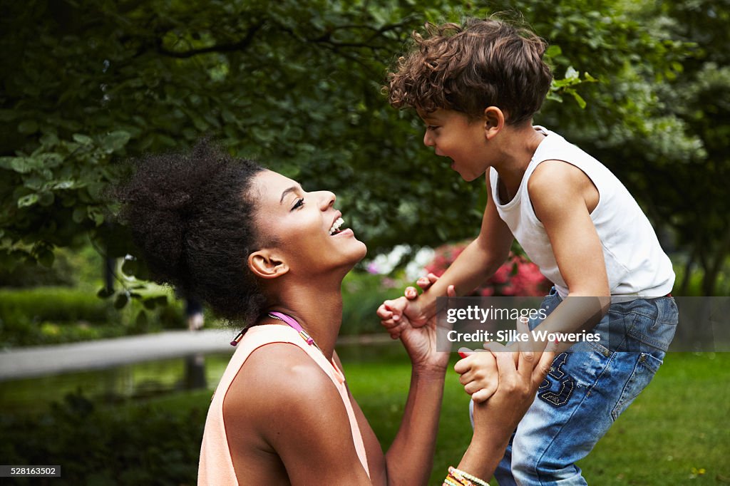 Mother with son (4-5) playing in park