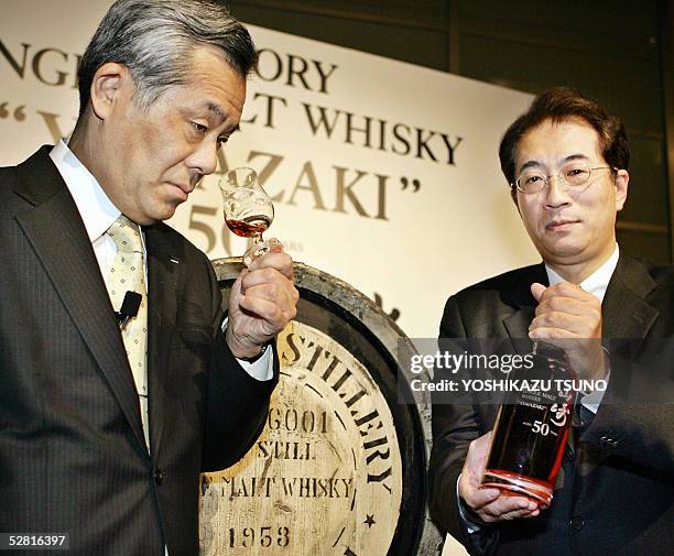 This 11 May 2005 file pcture shows Japan's liquour giant Suntory chief blender Seiichi Koshimizu tastes 50-year-old single malt whisky while...