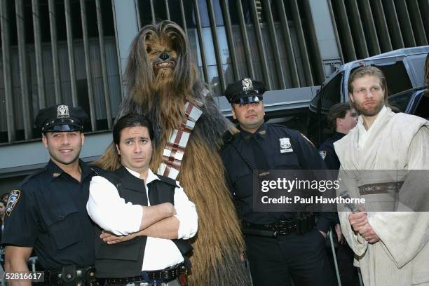 Guests in costume as Han Solo, Chewbacca, and Obi-Wan Kenobi pose with New York City Police officers at the premiere of "Star Wars: Episode III...